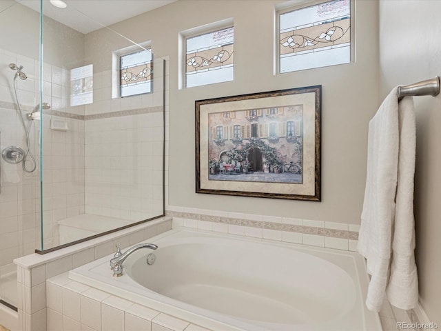 bathroom featuring separate shower and tub