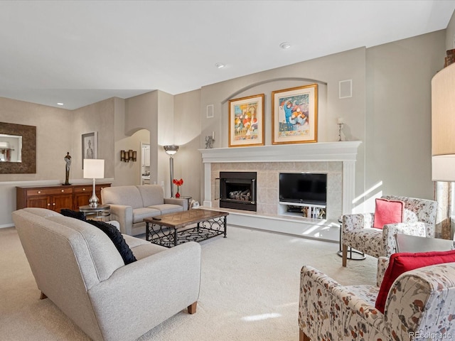 carpeted living room with a fireplace