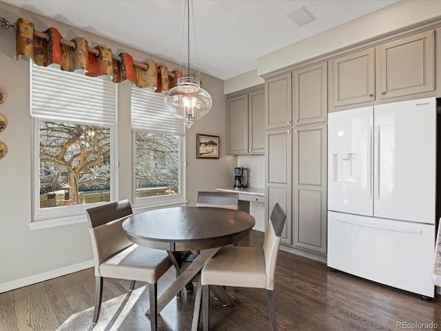 dining area featuring dark wood-type flooring