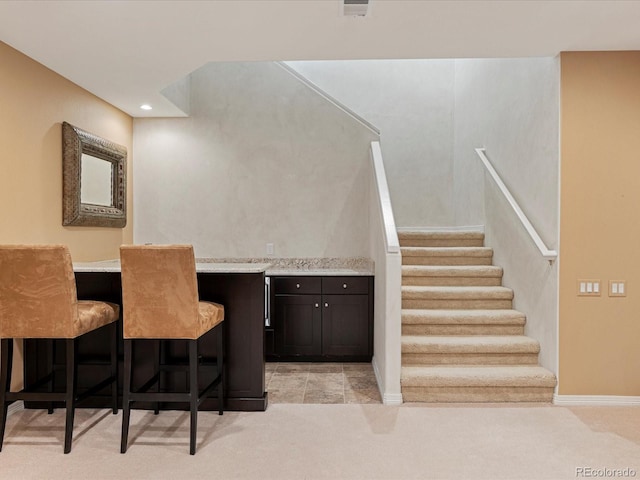 interior space with bar area and carpet flooring