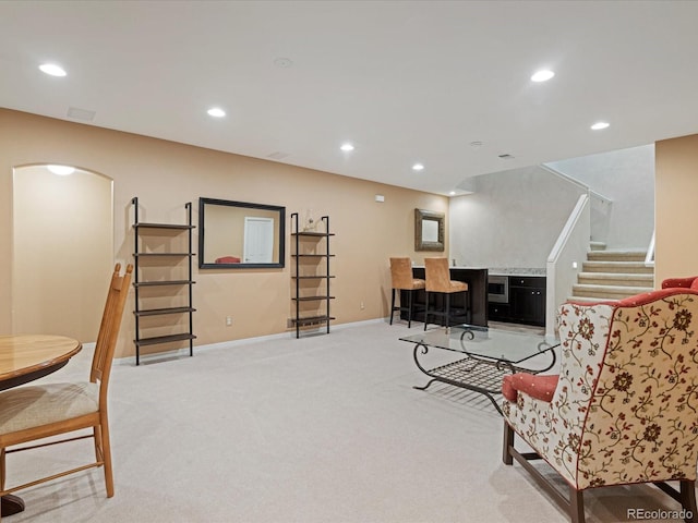 interior space with indoor bar and light colored carpet