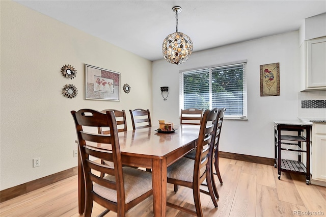 dining area featuring a notable chandelier and light hardwood / wood-style flooring