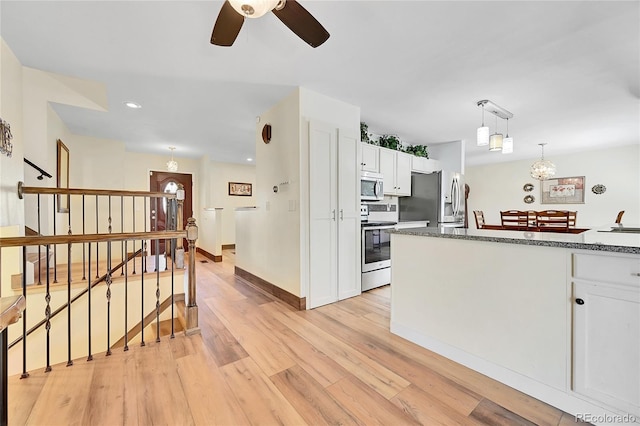 kitchen featuring white cabinetry, appliances with stainless steel finishes, light hardwood / wood-style floors, and pendant lighting