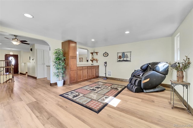 living area featuring ceiling fan and light hardwood / wood-style flooring