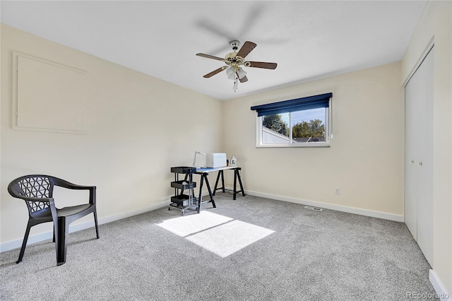 living area featuring carpet and ceiling fan