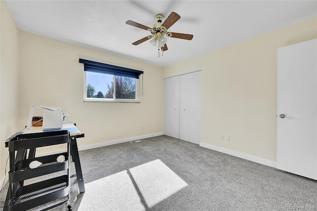 home office featuring light colored carpet and ceiling fan