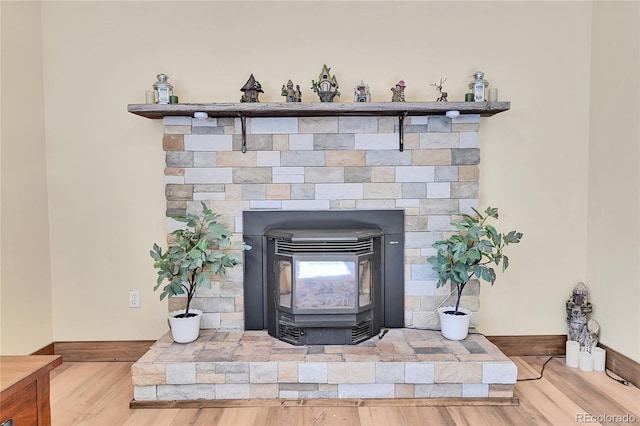 details with hardwood / wood-style floors and a wood stove