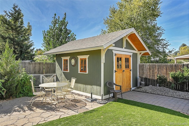 view of outbuilding with a lawn