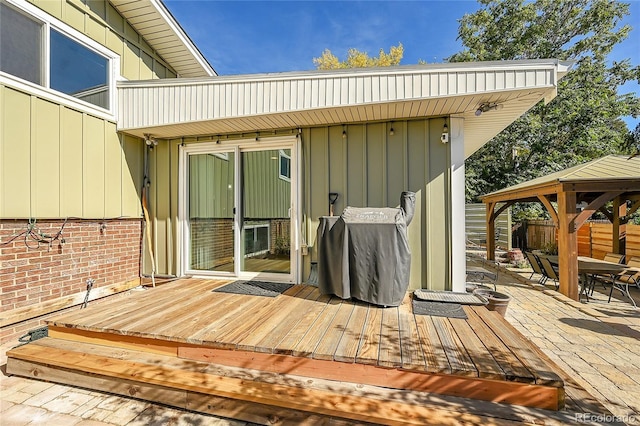 deck with a grill, a gazebo, and a patio area