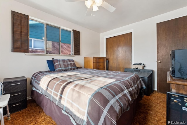 bedroom with dark colored carpet and ceiling fan