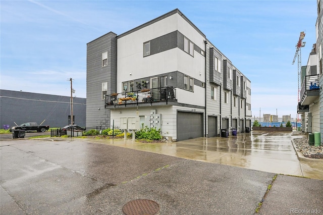 1285 W 9th Ave, Denver, CO 80204 - view of building exterior with driveway, a garage, and central air condition unit
