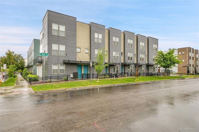 1285 W 9th Ave, Denver, CO 80204 - view of building exterior with fence and a residential view
