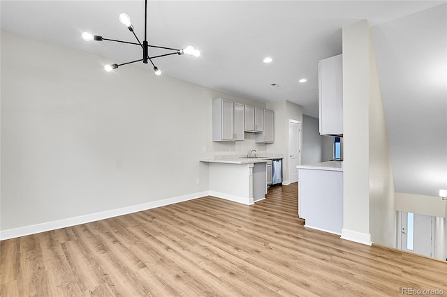 1285 W 9th Ave, Denver, CO 80204 - unfurnished living room featuring a chandelier, light wood finished floors, a sink, baseboards, and recessed lighting