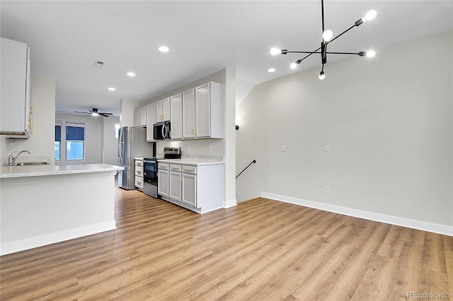 1285 W 9th Ave, Denver, CO 80204 - kitchen featuring stainless steel appliances, a chandelier, light countertops, light wood-style floors, and a sink