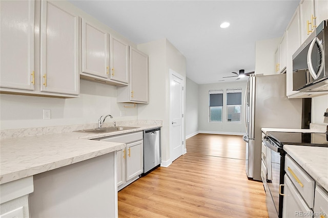 1285 W 9th Ave, Denver, CO 80204 - kitchen with appliances with stainless steel finishes, a sink, light wood-type flooring, light countertops, and recessed lighting