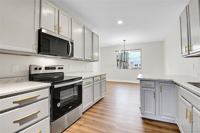 1285 W 9th Ave, Denver, CO 80204 - kitchen with appliances with stainless steel finishes, dark wood-style flooring, light countertops, gray cabinets, and recessed lighting