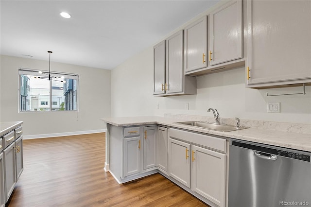 1285 W 9th Ave, Denver, CO 80204 - kitchen featuring dishwasher, light wood-style floors, a sink, light countertops, and a peninsula