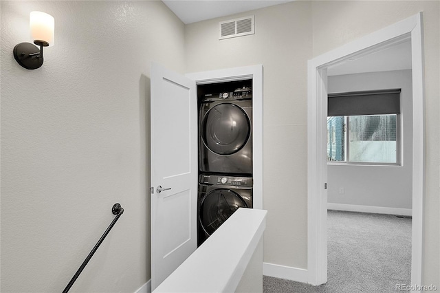 1285 W 9th Ave, Denver, CO 80204 - clothes washing area with stacked washing machine and dryer, baseboards, and carpet flooring