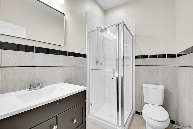 1285 W 9th Ave, Denver, CO 80204 - bathroom featuring tile walls, a stall shower, toilet, vanity, and wainscoting