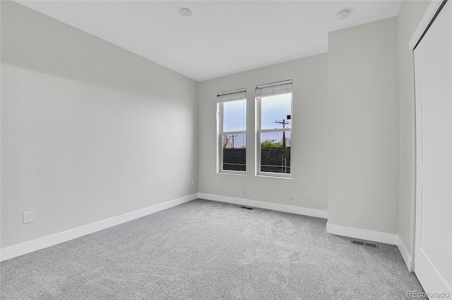 1285 W 9th Ave, Denver, CO 80204 - empty room featuring light carpet, baseboards, and a smoke detector