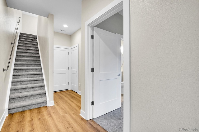 1285 W 9th Ave, Denver, CO 80204 - hallway with light wood-style flooring, stairway, baseboards, and recessed lighting