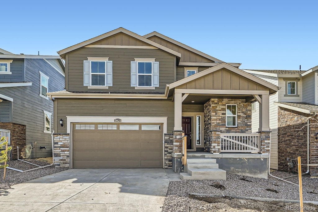 craftsman inspired home featuring stone siding, a porch, board and batten siding, concrete driveway, and a garage