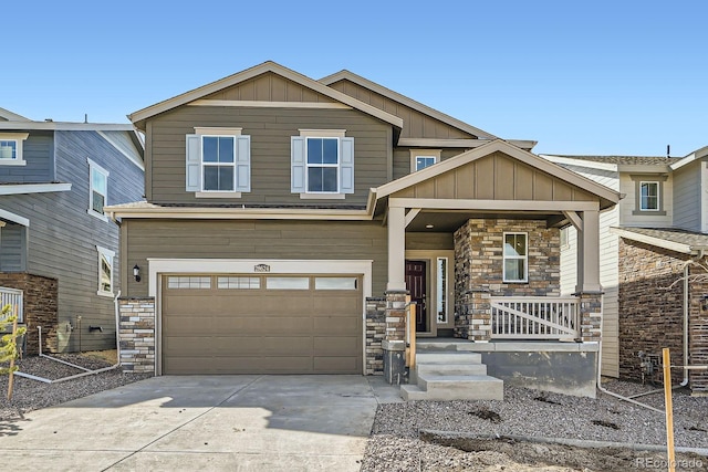 craftsman inspired home featuring stone siding, a porch, board and batten siding, concrete driveway, and a garage