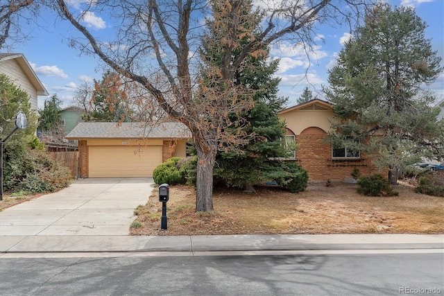 view of front of property with concrete driveway, an attached garage, and brick siding