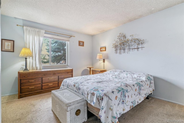 carpeted bedroom featuring baseboards and a textured ceiling