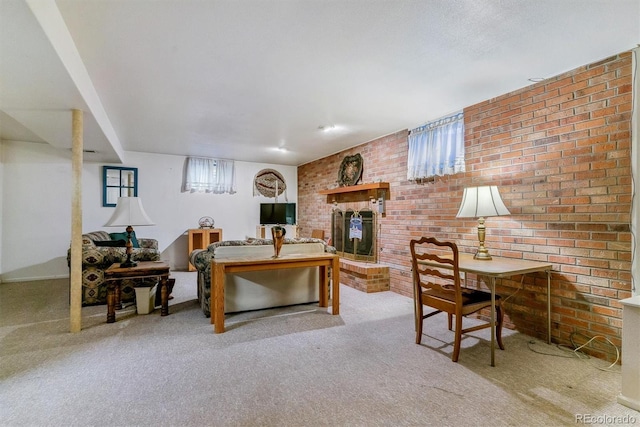 carpeted living room with a brick fireplace and brick wall