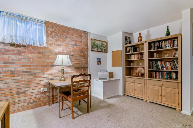 home office with light carpet, brick wall, and baseboards