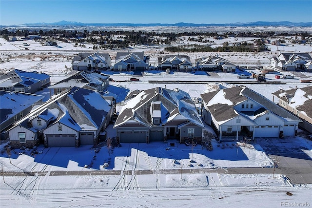 snowy aerial view with a mountain view