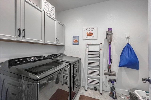 laundry area with cabinets and independent washer and dryer