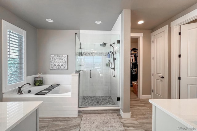 bathroom featuring vanity and shower with separate bathtub