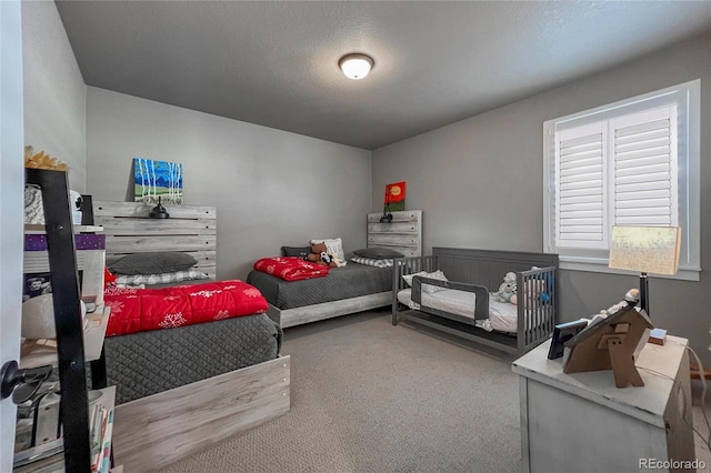 bedroom with carpet flooring and a textured ceiling