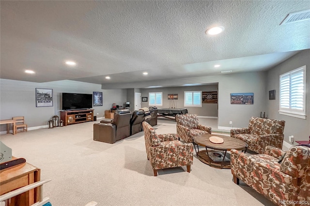 living room featuring light colored carpet and a textured ceiling