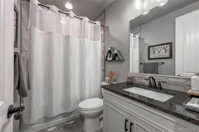 full bathroom featuring vanity, shower / tub combo, and toilet