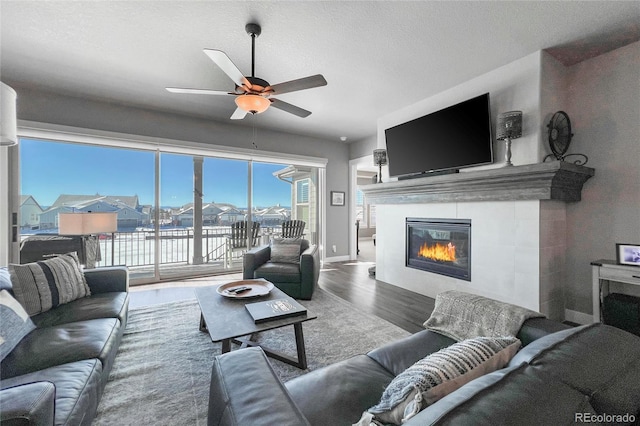 living room featuring hardwood / wood-style floors, a textured ceiling, and ceiling fan