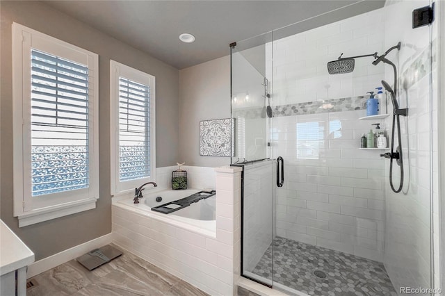 bathroom with shower with separate bathtub