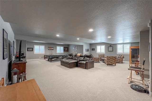 living room featuring carpet and a textured ceiling