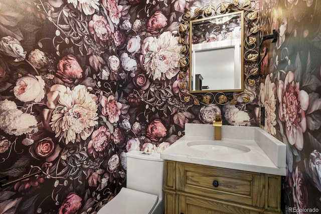 7404 La Quinta Ln, Lone Tree, CO 80124 - half bath with wallpapered walls, toilet, and vanity