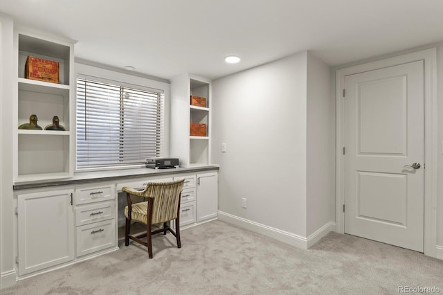7404 La Quinta Ln, Lone Tree, CO 80124 - office area featuring built in desk, light carpet, and baseboards