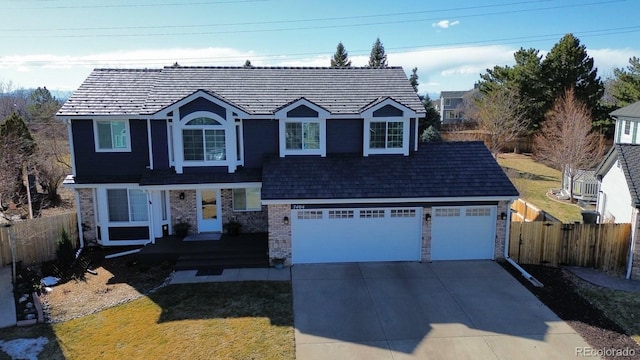 7404 La Quinta Ln, Lone Tree, CO 80124 - traditional home featuring driveway, brick siding, a garage, and a porch