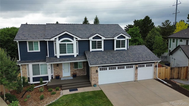 7404 La Quinta Ln, Lone Tree, CO 80124 - view of front facade with a porch, concrete driveway, and brick siding