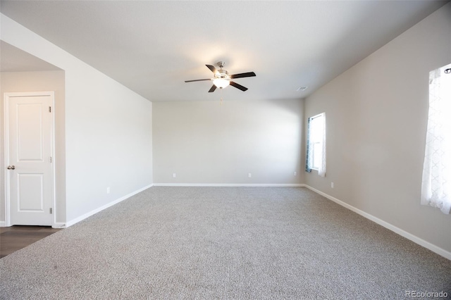 carpeted empty room featuring ceiling fan