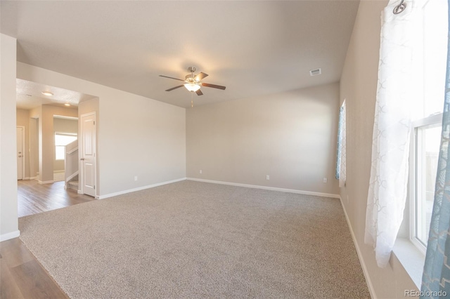 spare room with ceiling fan and carpet