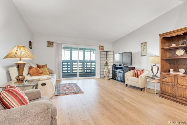 living room with lofted ceiling and light wood-type flooring