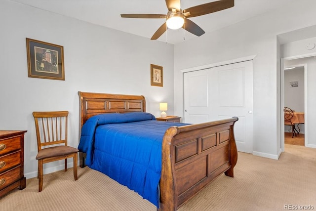 carpeted bedroom with ceiling fan and a closet