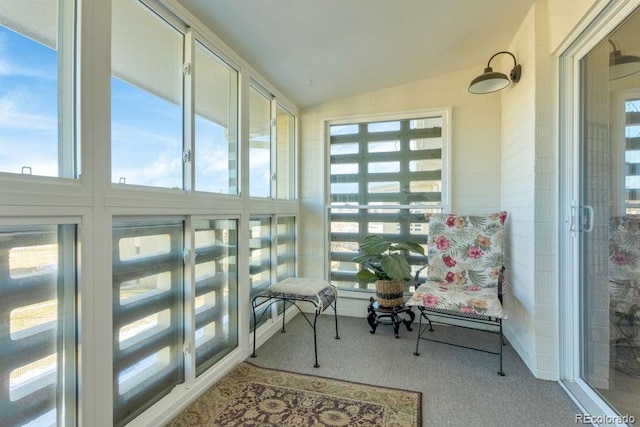 sunroom featuring vaulted ceiling