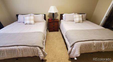 bedroom featuring light colored carpet